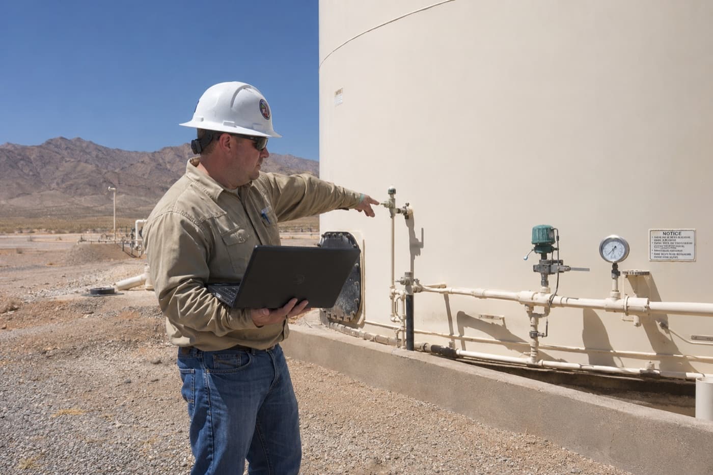 A coatings inspector checking tank valves and gauges on site