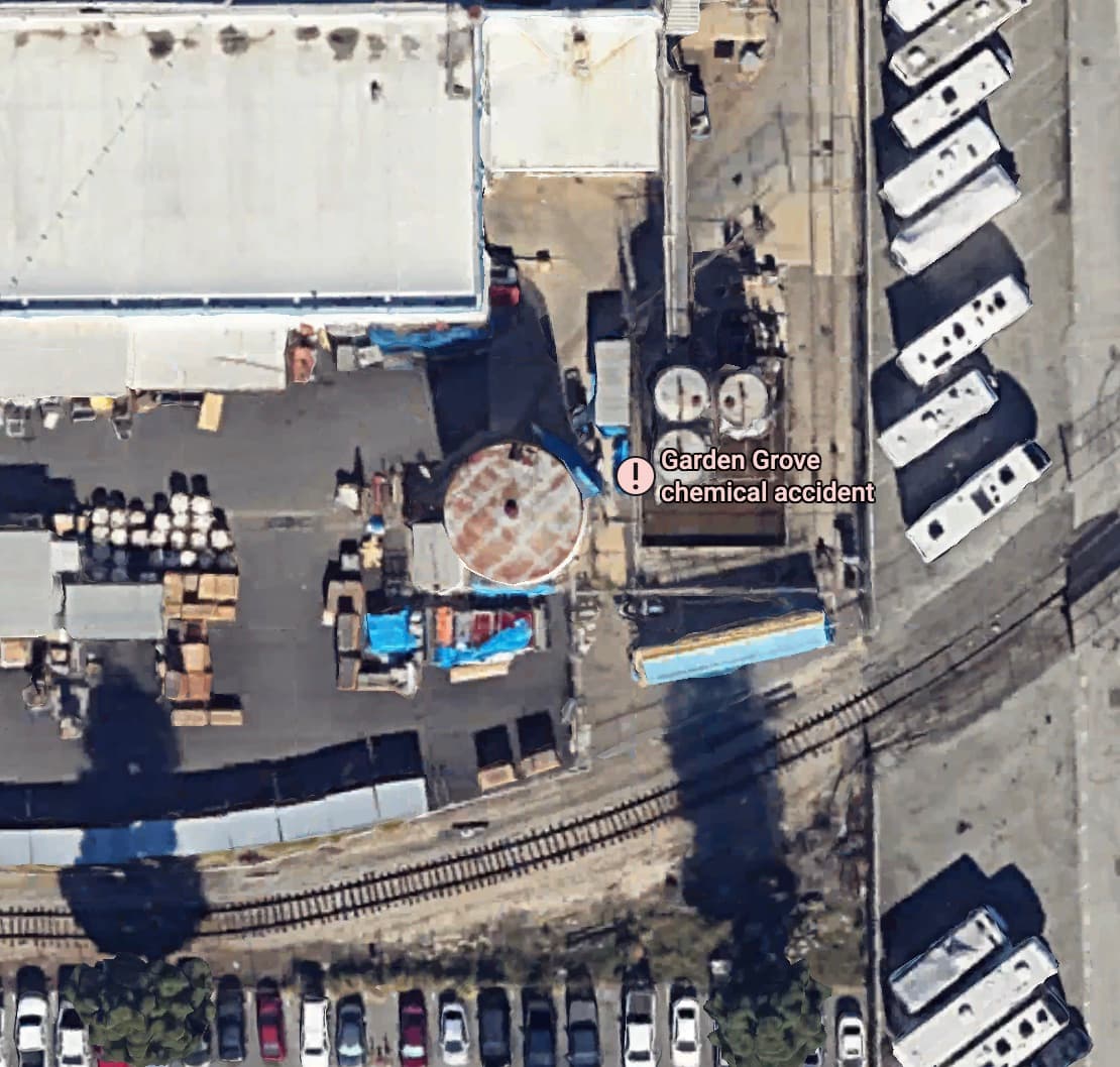 Overhead view of the storage tanks at the Garden Grove facility, with a mobile-home community and rail line immediately adjacent.