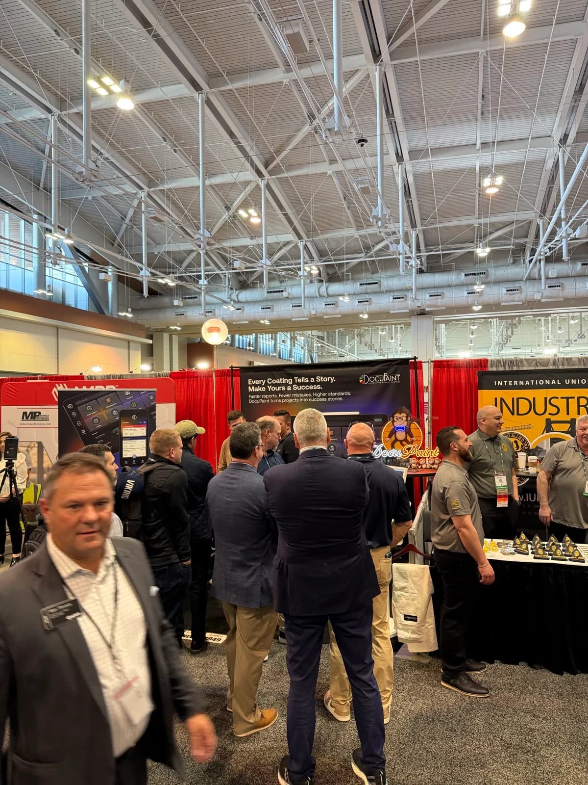 The trade-show floor with attendees gathered around the booth